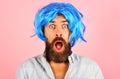 Surprised bearded man in blue wig. Party time. Fashion concept. Barbershop advertise. Handsome man with beard and Royalty Free Stock Photo