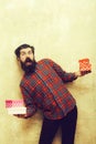 Surprised bearded man holding colorful gift boxes stacked in hands Royalty Free Stock Photo