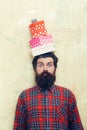 Surprised bearded man holding colorful gift boxes stacked on head Royalty Free Stock Photo