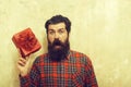 Surprised bearded man with red gift box with bow Royalty Free Stock Photo