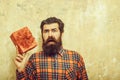 Surprised bearded man with red gift box with bow Royalty Free Stock Photo