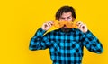 Surprised bearded man wearing funny party glasses on yellow background, copy space, party goer Royalty Free Stock Photo