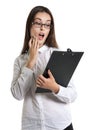 Surprised beautiful woman with a clipboard in his hands. Long-haired brunette in glasses and a white shirt. Shock, surprise. human Royalty Free Stock Photo
