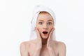 Surprised Beautiful Young Woman After Bath with A Towel On Her Head Isolated On white Background. Skin Care And Spa Royalty Free Stock Photo