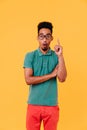 Surprised black man in big stylish glasses standing on colorful background. Cheerful guy in summer Royalty Free Stock Photo
