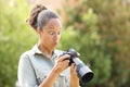 Surprised black photographer checking photos on camera Royalty Free Stock Photo