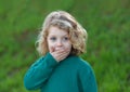 Surprised blond child covering his mouth Royalty Free Stock Photo