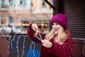 Surprised blonde girl dressed in stylish clothes,sets fire to glowing sparklers at the Christmas fair in Kiev Royalty Free Stock Photo