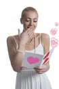 Surprised blonde girl reads valentine postcard