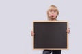 Surprised boy holding blackboard. Black copy space. Template. Mockup