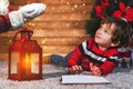 Surprised boy looking at santa claus while writing him the letter at christmas Royalty Free Stock Photo