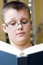 Surprised boy reading a book