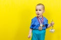 Surprised boy with sports awards