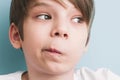 Surprised boy twisted his mouth in grimace of perplexity Royalty Free Stock Photo