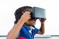 Surprised boy using virtual reality headset in classroom Royalty Free Stock Photo
