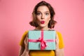 Surprised brunette woman with bright makeup holding present, loo