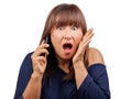 Surprised brunette woman talking mobile phone isolated