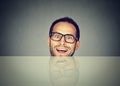 Surprised business man hiding under table Royalty Free Stock Photo