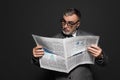 surprised businessman in eyeglasses reading newspaper Royalty Free Stock Photo