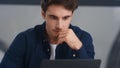 Surprised businessman getting good news letter on computer in office. Royalty Free Stock Photo