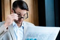 Businessman in glasses reading newspaper in cafe Royalty Free Stock Photo