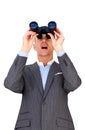 Surprised businessman looking through binoculars