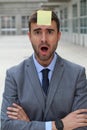 Surprised businessman with a note on his forehead Royalty Free Stock Photo