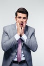 Surprised businessman over gray background Royalty Free Stock Photo