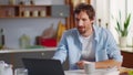 Surprised businessman reading good news on laptop screen at home Royalty Free Stock Photo