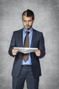 Surprised businessman reading a newspaper Royalty Free Stock Photo