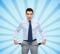 Surprised businessman showing empty pockets Royalty Free Stock Photo