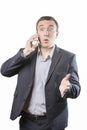 Surprised businessman talking on the phone, isolated on white Royalty Free Stock Photo