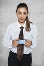 Surprised businesswoman holding a credit card in her hands