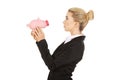 Surprised businesswoman holding a piggybank