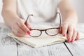 Surprised businesswoman taking off glasses while reading in office Royalty Free Stock Photo