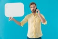 Surprised casual man holding a speech bubble and talking Royalty Free Stock Photo
