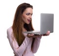 Surprised casual woman looking at her laptop