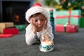 Surprised caucasian boy wearing santa hat, looking at snow globe at christmas time Royalty Free Stock Photo