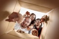 The people unpacking and opening carton box and looking inside Royalty Free Stock Photo