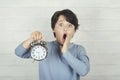 Surprised child holding alarm clock Royalty Free Stock Photo