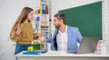 surprised child with man tutor in classroom. education