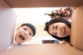 The surprised child and mom unpacking, opening the carton box and looking inside. Unboxing inside view, asian family Royalty Free Stock Photo