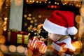 Surprised child opening Christmas gift Royalty Free Stock Photo