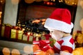 Surprised child opening Christmas gift Royalty Free Stock Photo