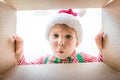 Surprised child unpack Christmas gift box