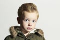 Surprised child in winter coat. fashion kid.children.khaki parka.little boy