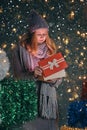 Surprised Christmas Winter girl opening magic Christmas Gift box and smiling. Royalty Free Stock Photo