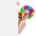 Surprised clown showing blank poster with copy space in studio Royalty Free Stock Photo