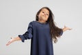 Portrait of one cute Caucasian preschool girl in beautiful blue dress isolated over white studio background. Royalty Free Stock Photo