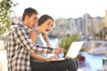 Surprised couple on vacation watching online content